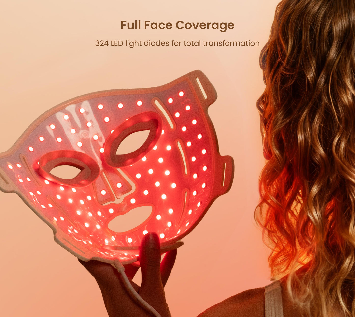 Fitlybuy Artemis LED therapy mask glowing red with 324 light diodes, held by a woman for skin rejuvenation.