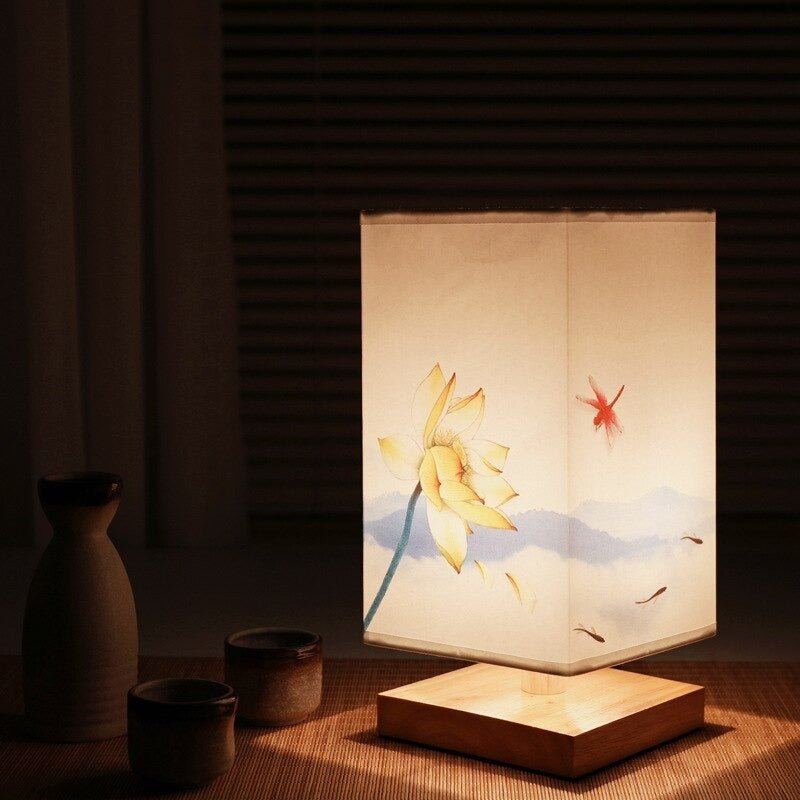 Fitlybuy bamboo table lamp with a rectangular shade featuring a painted lotus and dragonfly in a cozy, dim setting.