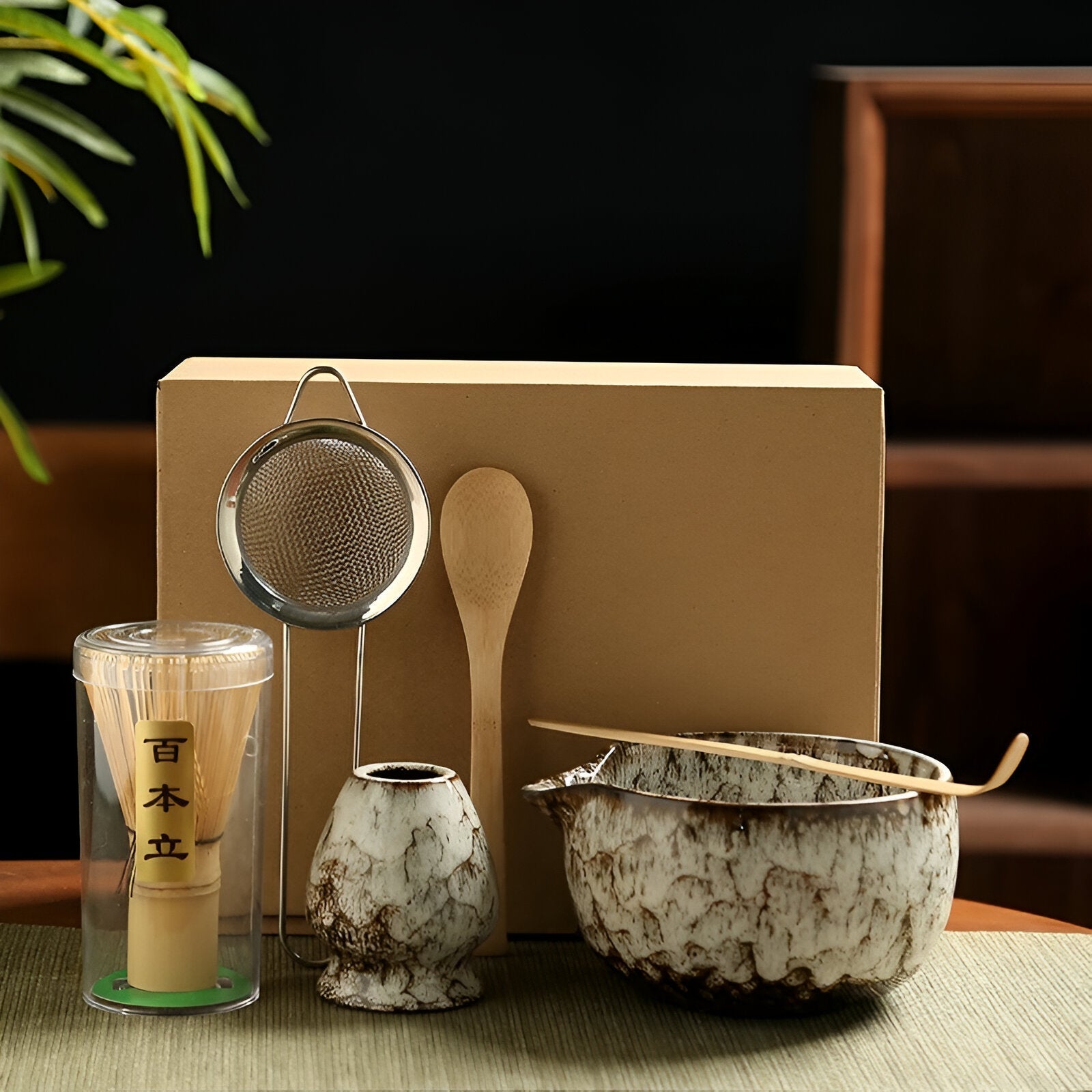 Fitlybuy 6-piece Japanese matcha set with ceramic bowl, whisk, scoop, holder, and strainer in front of a gift box.