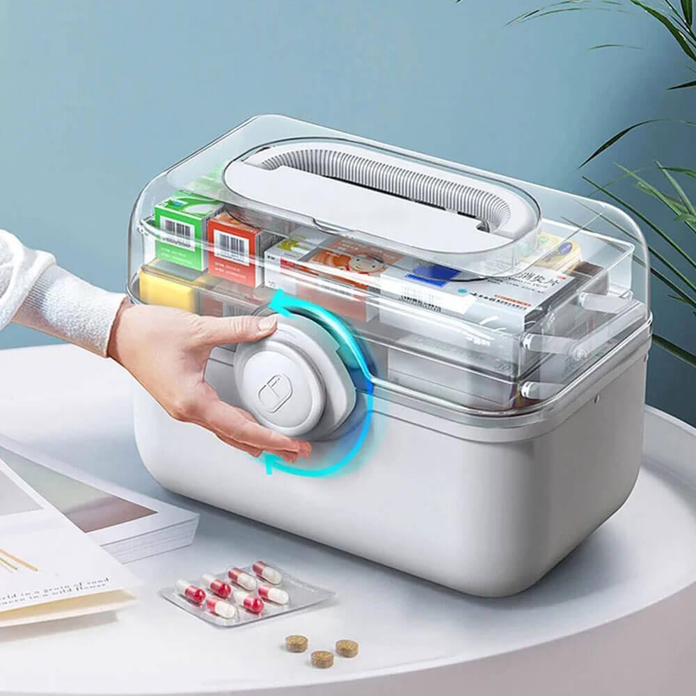 Fitlybuy MediSmart white pill organizer with clear lid, rotating lock, and handle, filled with medicine boxes.