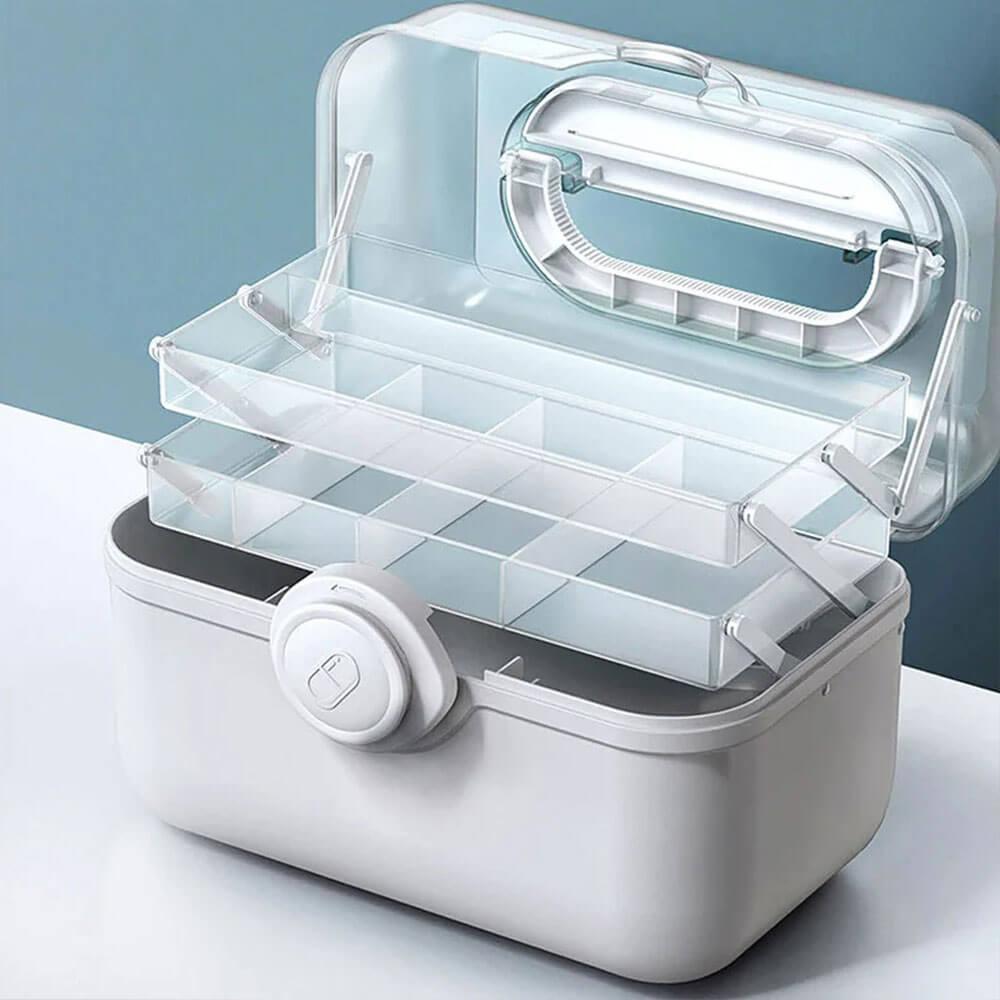 Fitlybuy MediSmart pill organizer: A white, portable medicine storage box with tiered, clear trays on a white surface.