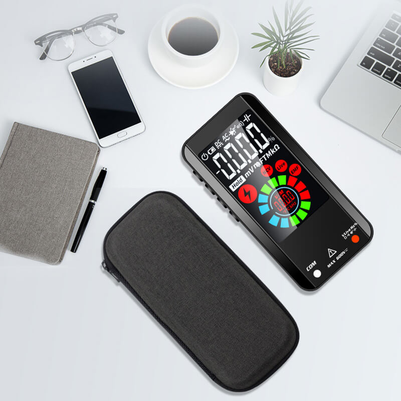 Fitlybuy smart digital multimeter with color screen and carrying case on a desk with laptop, phone, and coffee.