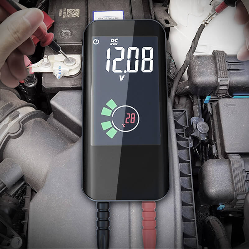 Fitlybuy black smart digital multimeter measuring car battery voltage, showing 12.08V and 28°C on a bright LCD screen.