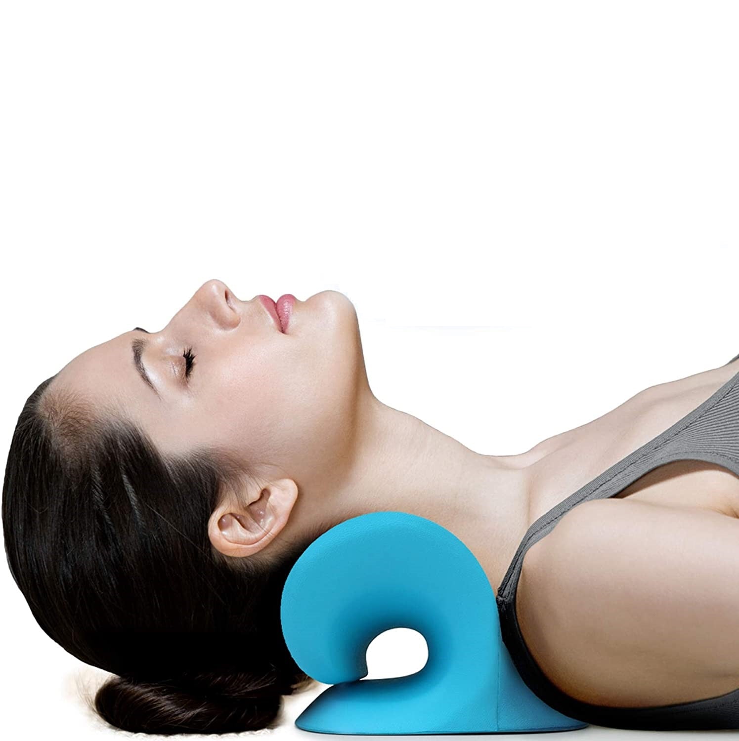 Woman lying down, using a blue, ergonomic Fitlybuy neck and shoulder stretcher to support her neck.