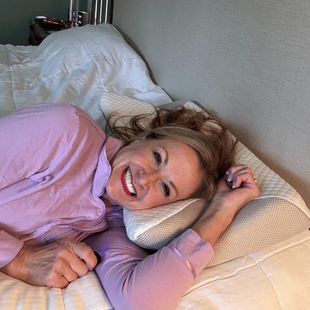 Woman lying on a white, textured Fitlybuy adaptive memory foam neck therapy pillow on a bed.