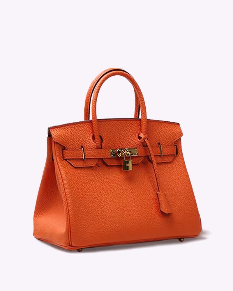 Bright orange textured leather Fitlybuy LuxeCarry handbag with gold lock hardware, top handles, and professional design.