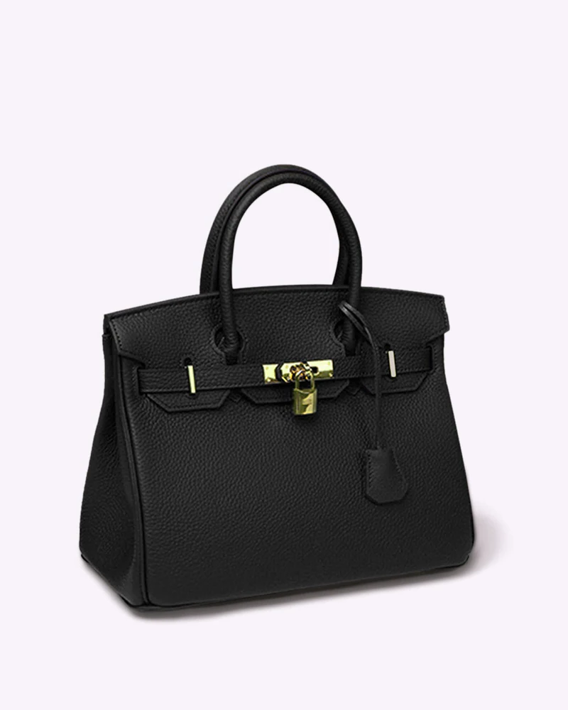Black pebble leather Fitlybuy LuxeCarry handbag with gold hardware, lock closure, and top handles on a white background.