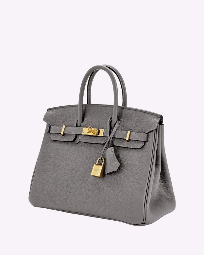 Fitlybuy LuxeCarry grey pebbled leather handbag with gold hardware, lock, and key clochette on a plain background.
