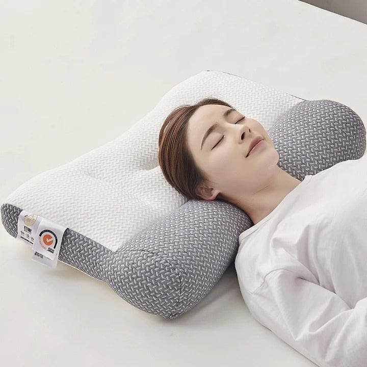 Woman sleeping on a Fitlybuy ergonomic white and grey foam pain relief pillow with a textured, contoured design.