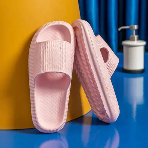 Light pink Fitlybuy Cloud Slides with ComfortFoam cushioning, featuring a textured, slip-on design in a bathroom setting.