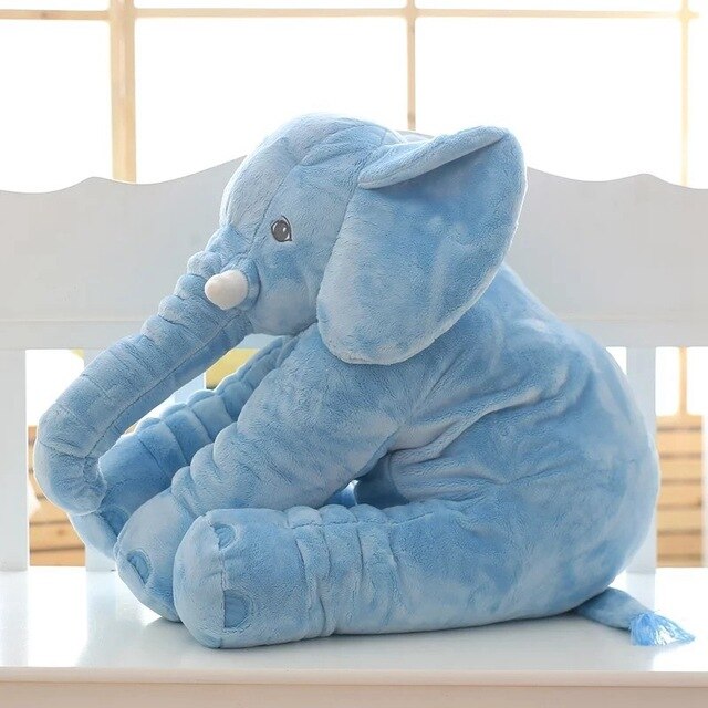 Fitlybuy ultra-soft, light blue plush elephant pillow for kids, sitting on a white bench near a bright window.