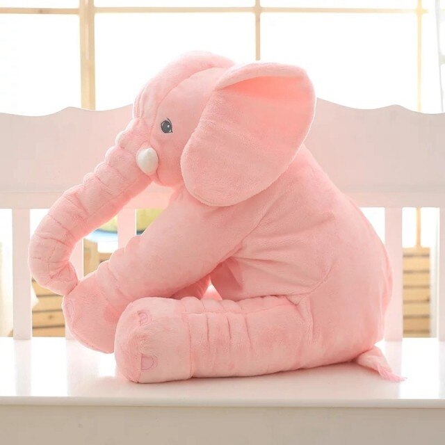 Fitlybuy soft pink plush elephant pillow sitting on a white crib bench, perfect for cuddling.