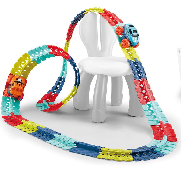 Fitlybuy MagniTrack: Colorful, flexible magnetic car track looping over a white child’s chair with two toy cars.