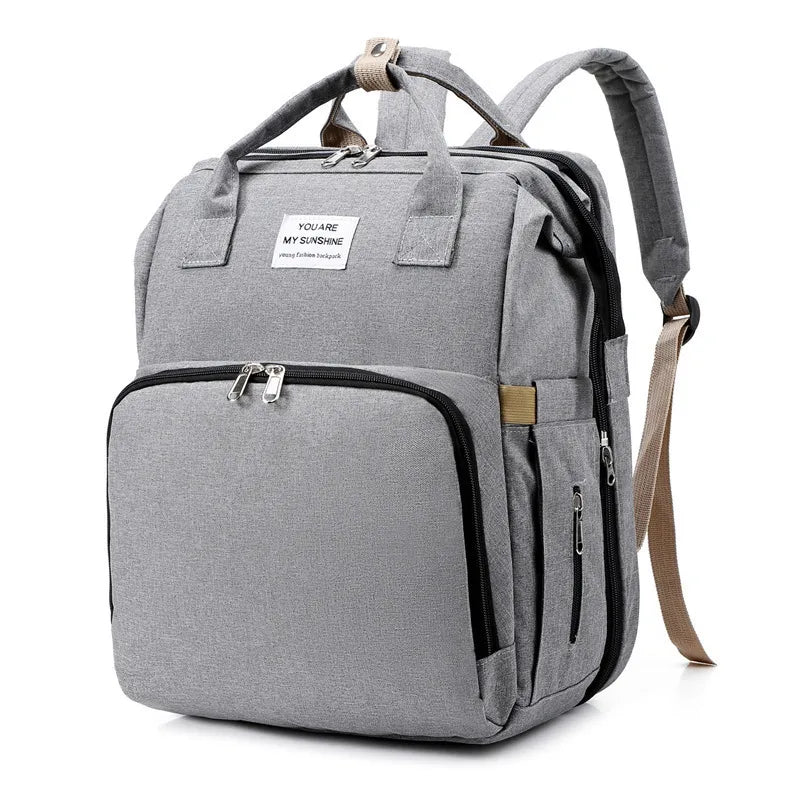 Grey Fitlybuy waterproof mummy backpack with USB charging, top handles, and a label reading "YOU ARE MY SUNSHINE."