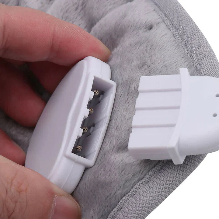 Hand connecting a white 4-pin plug to a soft, grey fleece Fitlybuy heating therapy pad for muscle relief.
