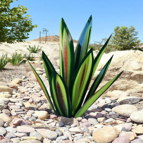 Fitlybuy handcrafted metal agave sculpture with green and rust-toned leaves, set in a dry desert rock garden.