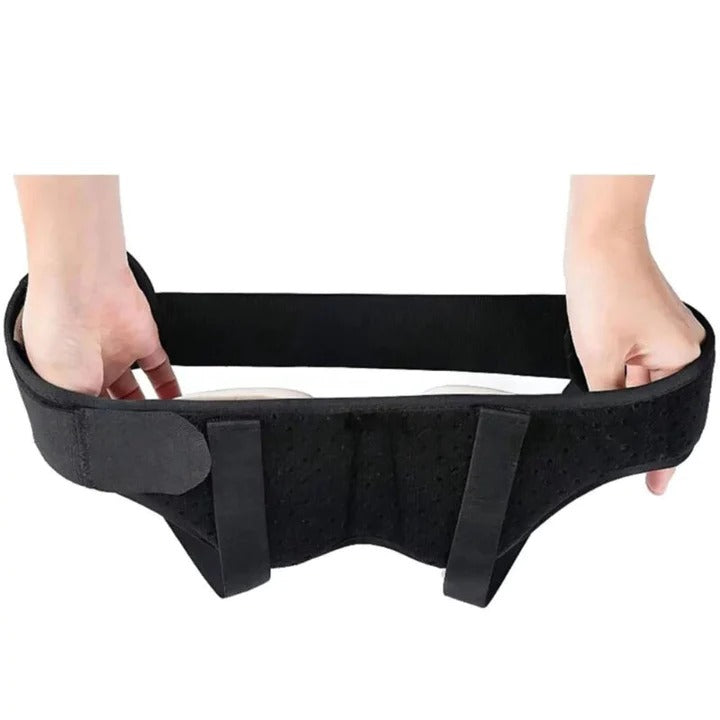 Hands holding a black, adjustable Fitlybuy hernia support belt with ComfortFlex compression pads against a white background.
