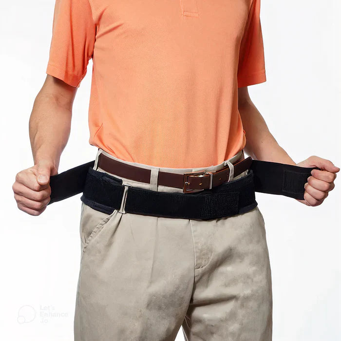 Person wearing a black Fitlybuy Sciatica Relief Belt with ComfortFlex support over khakis and a brown leather belt.