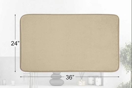 Beige rectangular Fitlybuy memory foam bath mat, 24x36 inches, shown with room setting background.