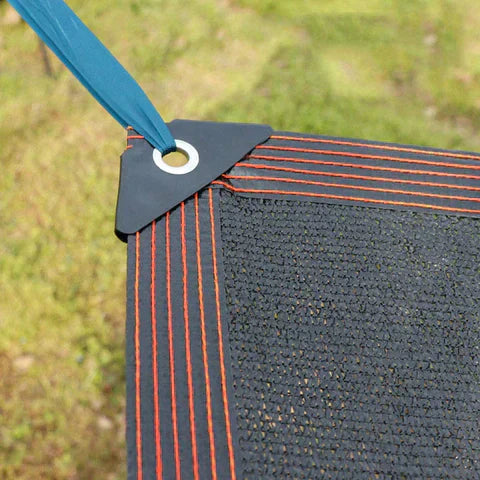 Fitlybuy black UV shade net with reinforced orange stitched edges, metal grommet, and blue tie-down cord over grass.