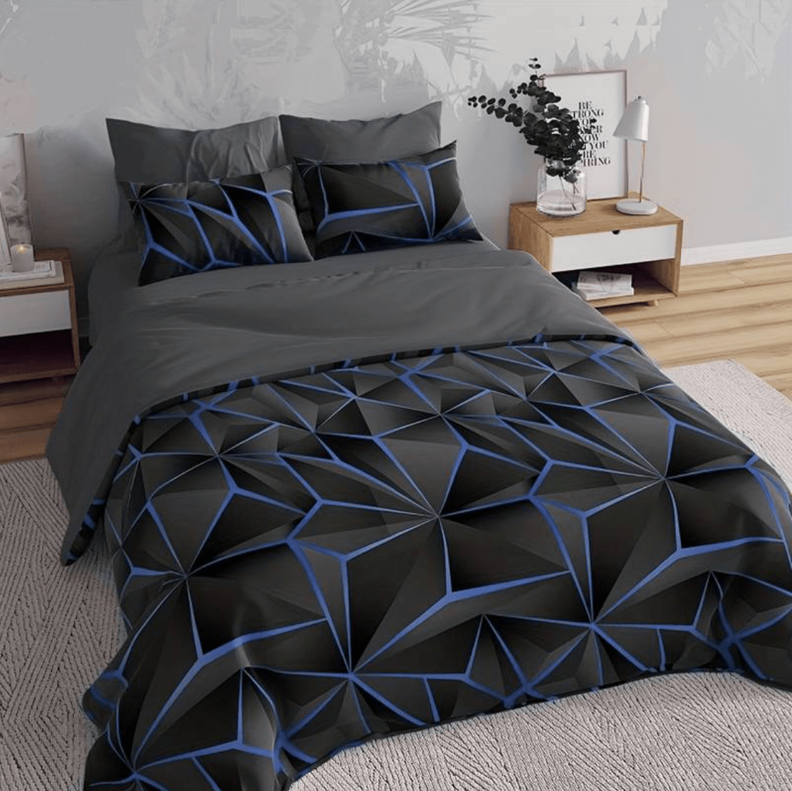 Fitlybuy Hilton quilt set: black and blue geometric patterned bedding on a bed in a modern, neutral bedroom.