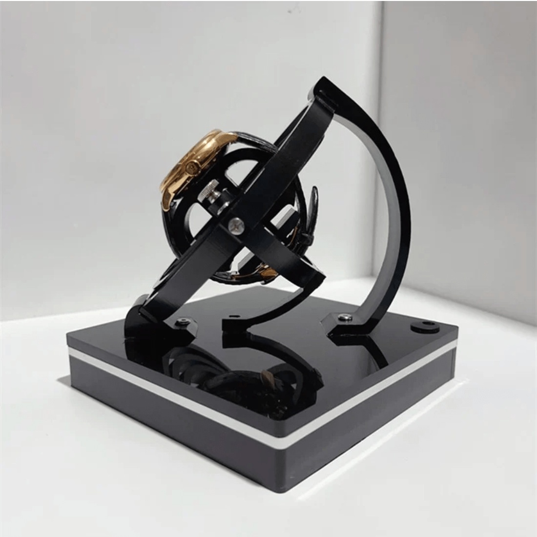 Black Fitlybuy luxury automatic watch winder with a gold watch rotating in a sleek, modern display stand.