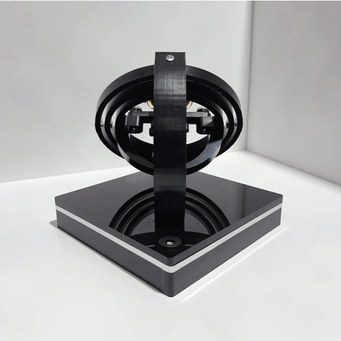 Fitlybuy luxury black automatic watch winder featuring a modern orbital rotating design on a square base.