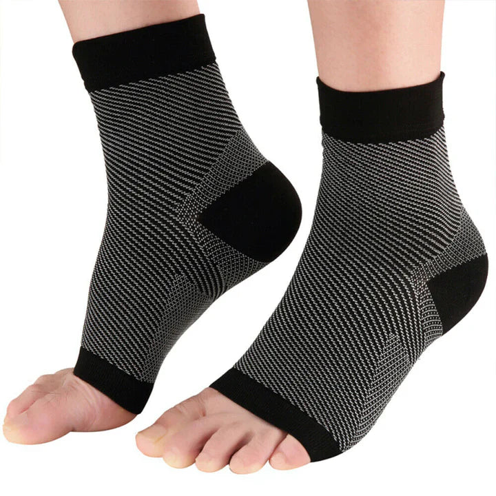 Fitlybuy black and grey compression ankle sleeves with open-toe design for foot support on a person's feet.